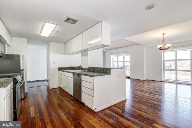 250 President St Unit 308, Baltimore, MD 21202 - kitchen with visible vents, dark countertops, appliances with stainless steel finishes, a sink, and dark wood-type flooring