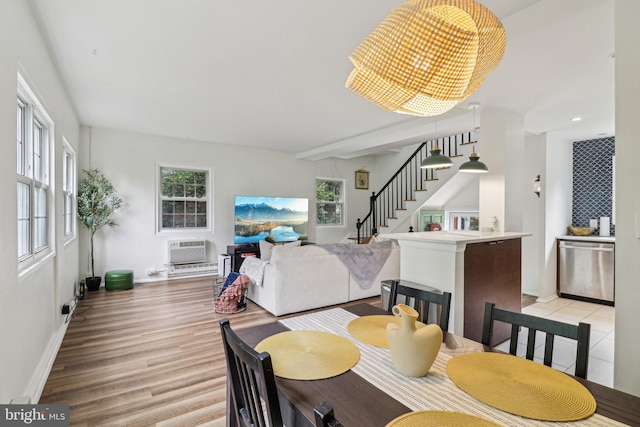 1240 Martha Custis Dr, Alexandria, VA 22302 - dining area featuring stairs, light wood-style floors, baseboards, and an AC wall unit