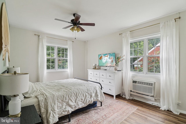 1240 Martha Custis Dr, Alexandria, VA 22302 - bedroom featuring a wall mounted air conditioner, light wood-style flooring, and a ceiling fan