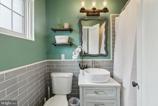 1240 Martha Custis Dr, Alexandria, VA 22302 - bathroom with vanity, toilet, tile walls, and a wainscoted wall