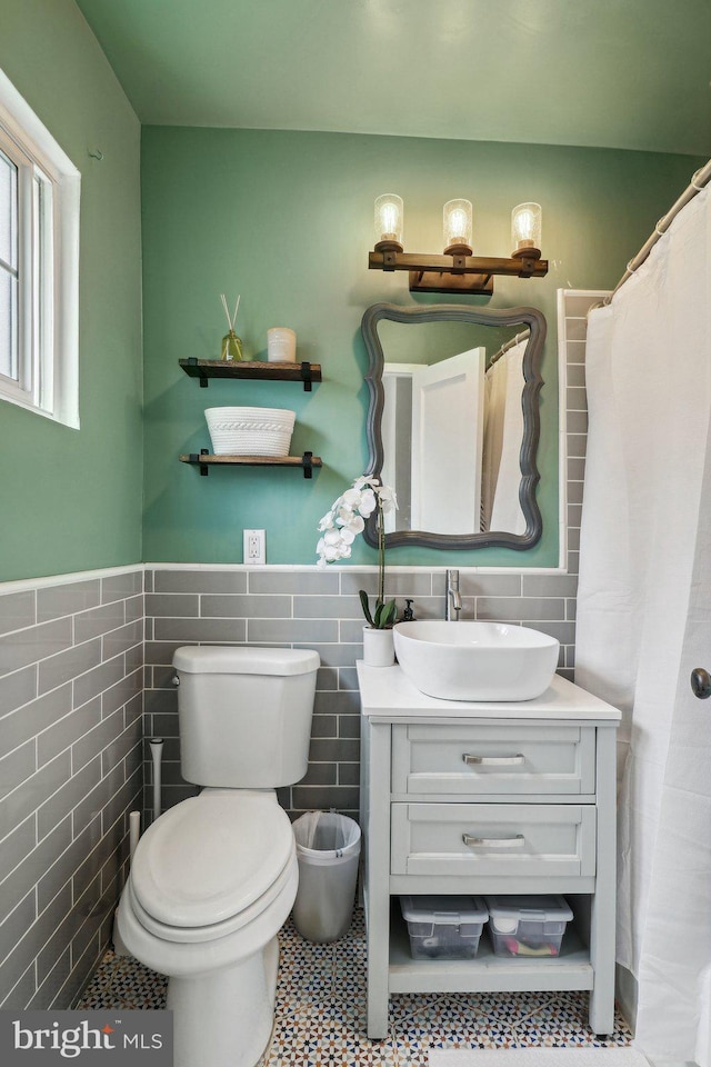 1240 Martha Custis Dr, Alexandria, VA 22302 - full bath with tile walls, vanity, toilet, and wainscoting