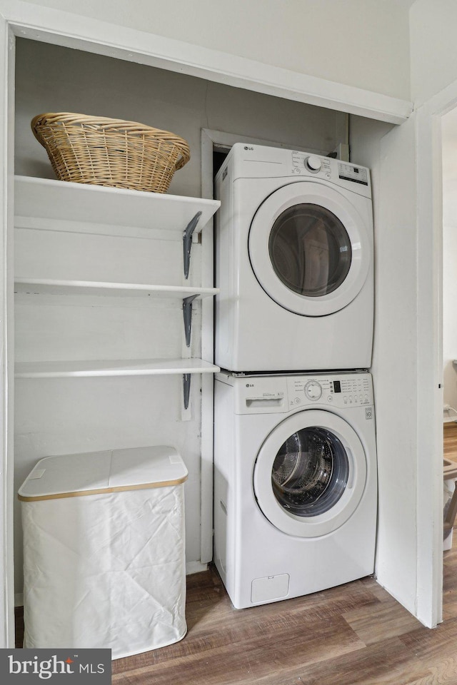 1240 Martha Custis Dr, Alexandria, VA 22302 - laundry room featuring stacked washing machine and dryer and wood finished floors