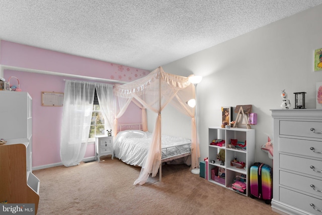 bedroom featuring carpet and a textured ceiling