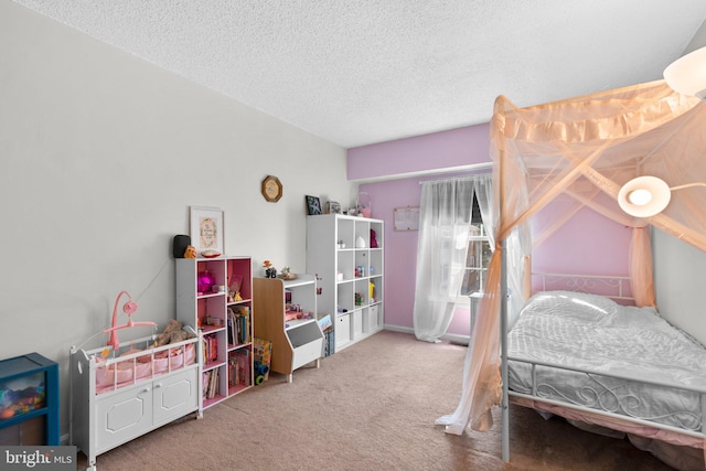 bedroom featuring a textured ceiling and carpet