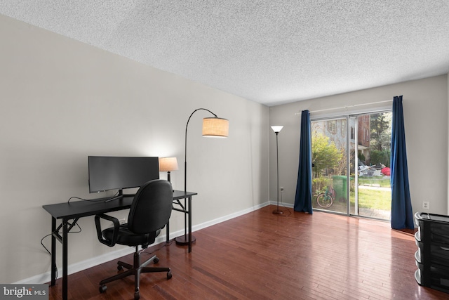 office space with a textured ceiling, baseboards, and wood finished floors