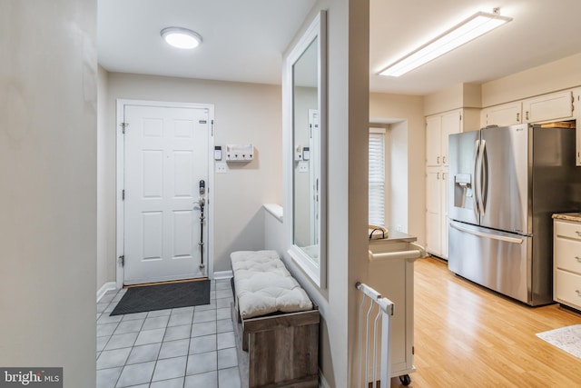 602 Lions Gate Ln, Odenton, MD 21113 - interior space featuring light tile patterned flooring, stainless steel fridge, baseboards, and white cabinets