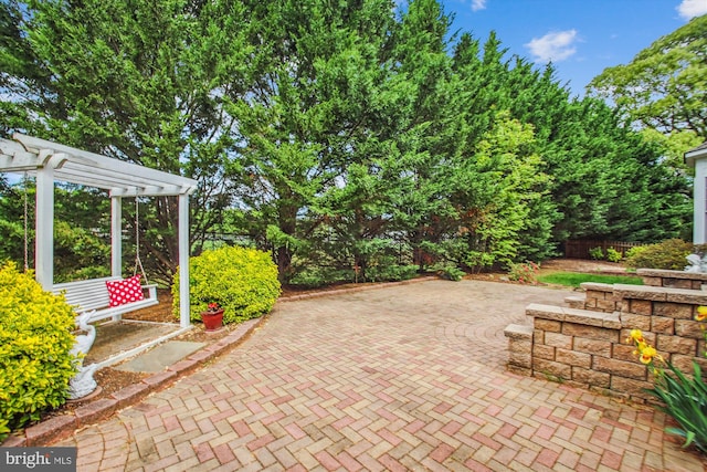 view of patio featuring fence and a pergola