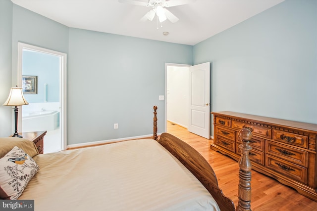 bedroom with ensuite bathroom, a ceiling fan, and light wood finished floors