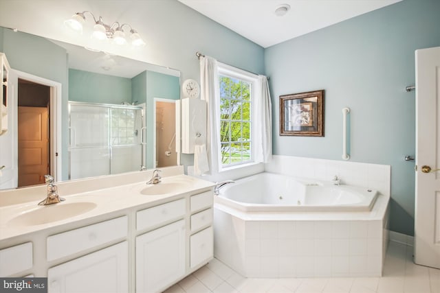 full bathroom with a whirlpool tub, a sink, a stall shower, and tile patterned flooring