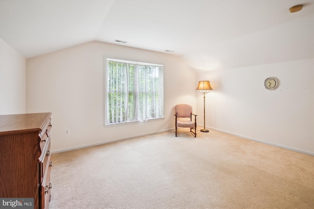 unfurnished room with baseboards, lofted ceiling, carpet flooring, and visible vents