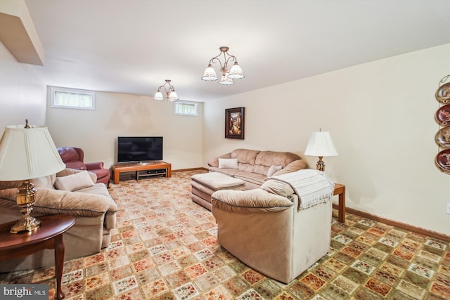 living room featuring baseboards and a notable chandelier