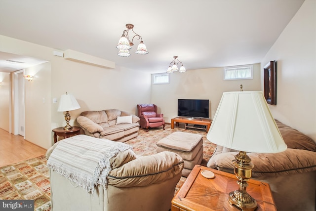 living area with light wood-style floors and a chandelier