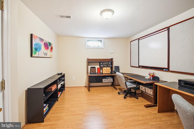 office space featuring wood finished floors and visible vents