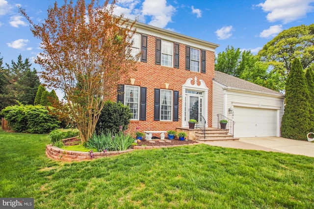 colonial-style house featuring an attached garage, driveway, and a front lawn