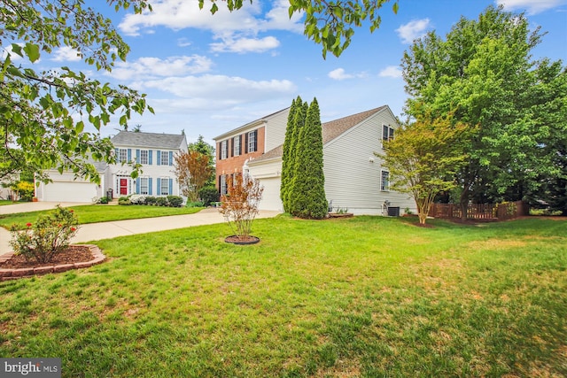 colonial-style house with fence, cooling unit, driveway, and a front yard