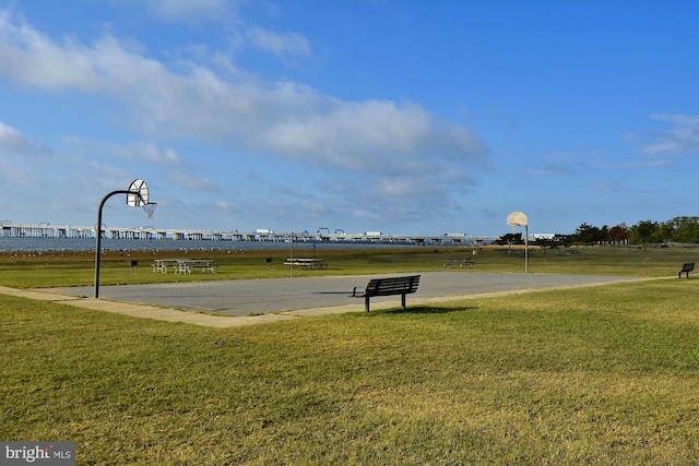 view of sport court with a yard
