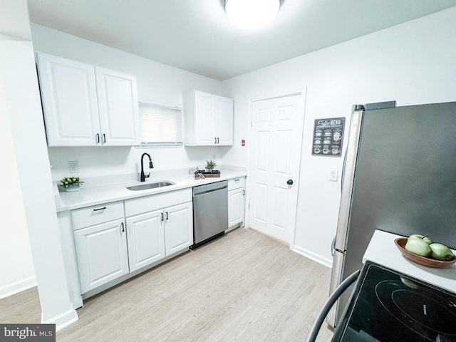 21 Onaway Pl, New Castle, DE 19720 - kitchen with a sink, stainless steel appliances, light wood finished floors, and white cabinetry