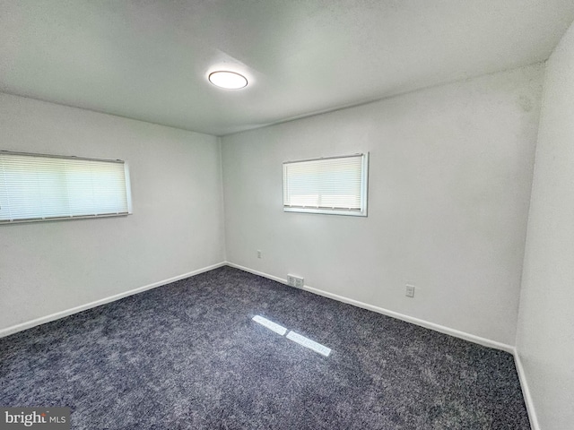 21 Onaway Pl, New Castle, DE 19720 - empty room with baseboards, plenty of natural light, dark carpet, and visible vents