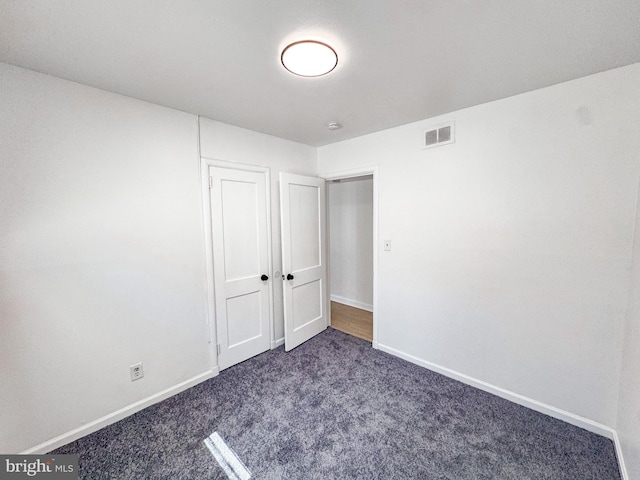 21 Onaway Pl, New Castle, DE 19720 - unfurnished bedroom featuring visible vents, baseboards, and dark colored carpet