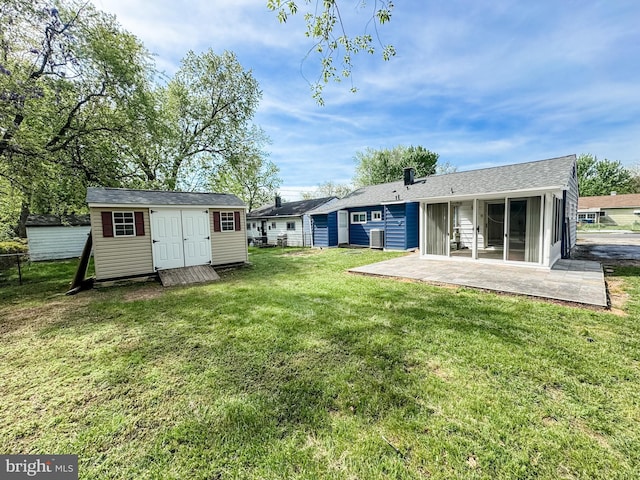 21 Onaway Pl, New Castle, DE 19720 - back of property with a storage shed, an outbuilding, a lawn, and a patio area