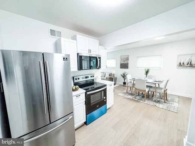 21 Onaway Pl, New Castle, DE 19720 - kitchen with white cabinets, appliances with stainless steel finishes, light countertops, light wood-style flooring, and visible vents