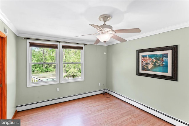 spare room featuring crown molding, ceiling fan, a baseboard heating unit, and light wood-type flooring