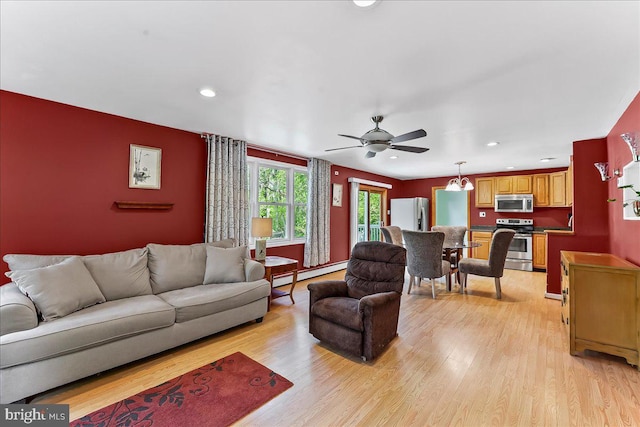 living area featuring recessed lighting, a baseboard radiator, light wood-style flooring, and a ceiling fan