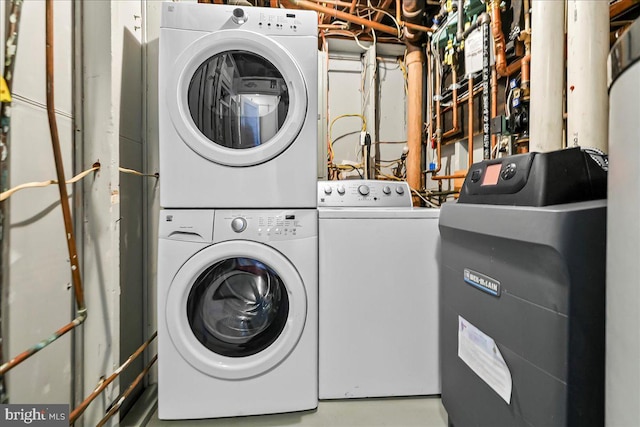 washroom featuring stacked washer / drying machine and laundry area