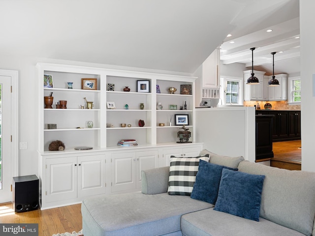 living area with recessed lighting, beam ceiling, and light wood-type flooring