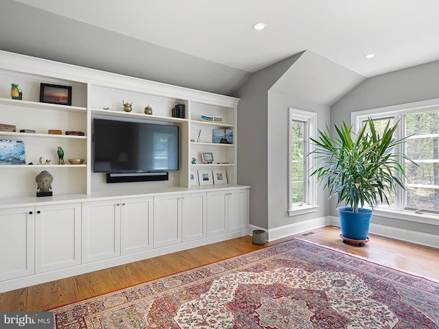 living room featuring recessed lighting, light wood-style flooring, lofted ceiling, and baseboards