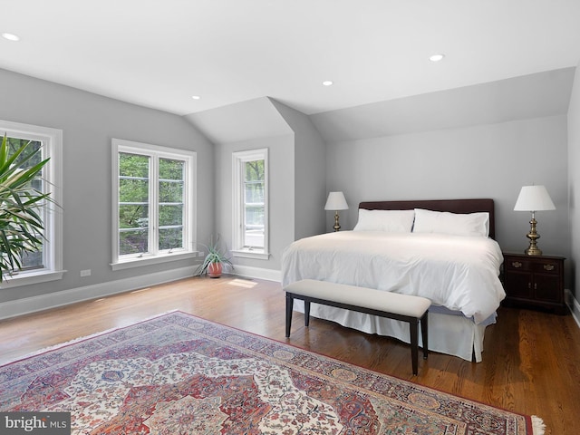 bedroom with baseboards, recessed lighting, wood finished floors, and lofted ceiling