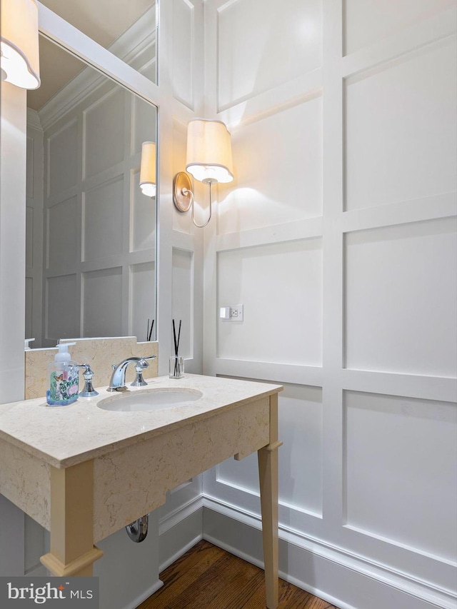 bathroom with a sink and wood finished floors