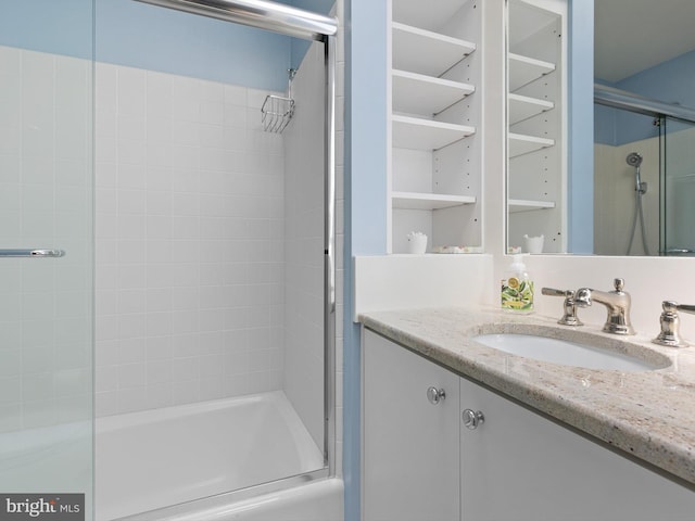 bathroom featuring vanity and a shower with shower door
