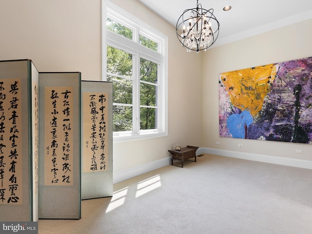 carpeted spare room featuring baseboards and a chandelier