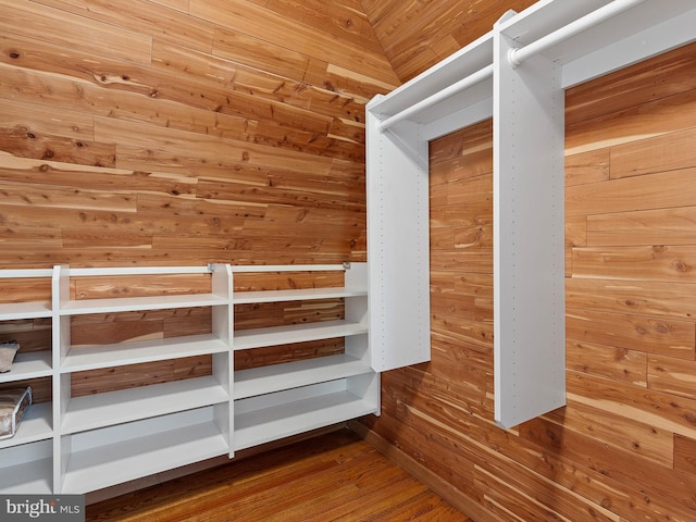 walk in closet with wood finished floors