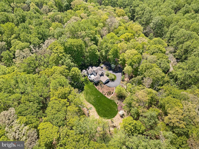 birds eye view of property featuring a view of trees