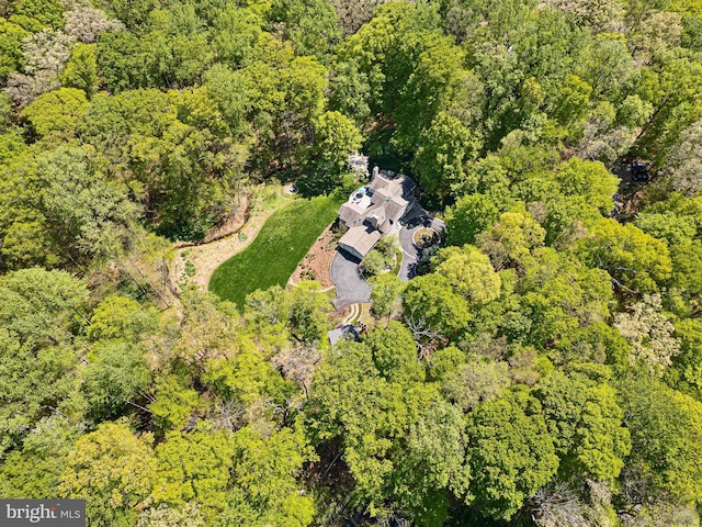 birds eye view of property with a wooded view