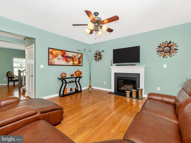 2004 Quandary Dr, Frederick, MD 21702 - living room featuring a ceiling fan, baseboards, a fireplace with flush hearth, and wood finished floors