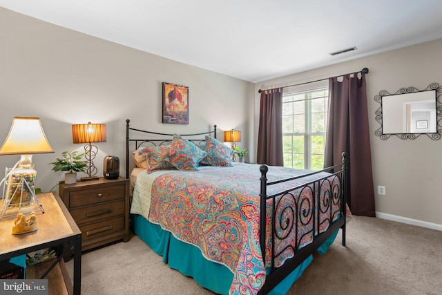 carpeted bedroom with baseboards and visible vents