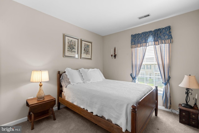 carpeted bedroom with baseboards and visible vents