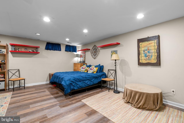 bedroom featuring baseboards, recessed lighting, and wood finished floors