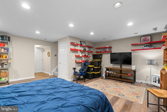bedroom with recessed lighting, baseboards, and wood finished floors