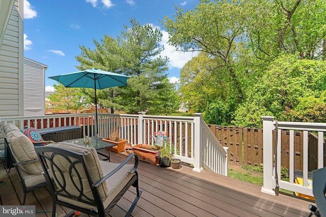 wooden terrace with outdoor dining area