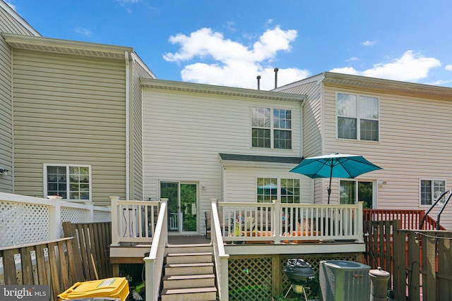 rear view of house featuring central air condition unit and a wooden deck