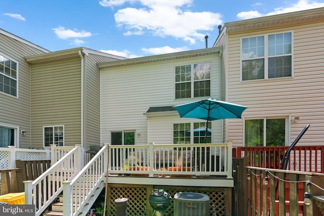 rear view of house with central air condition unit and a deck