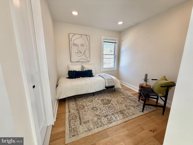 bedroom with baseboards, recessed lighting, and wood finished floors
