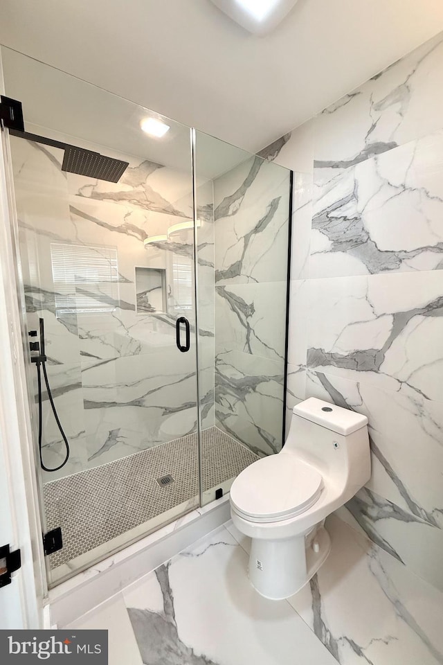 bathroom with a marble finish shower, stone wall, toilet, and marble finish floor