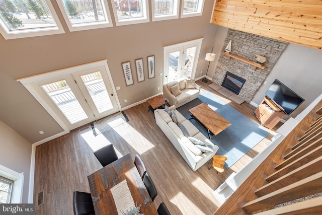 193 Greenbrier Dr, Mc Henry, MD 21541 - living room with a fireplace, french doors, baseboards, wood finished floors, and a towering ceiling