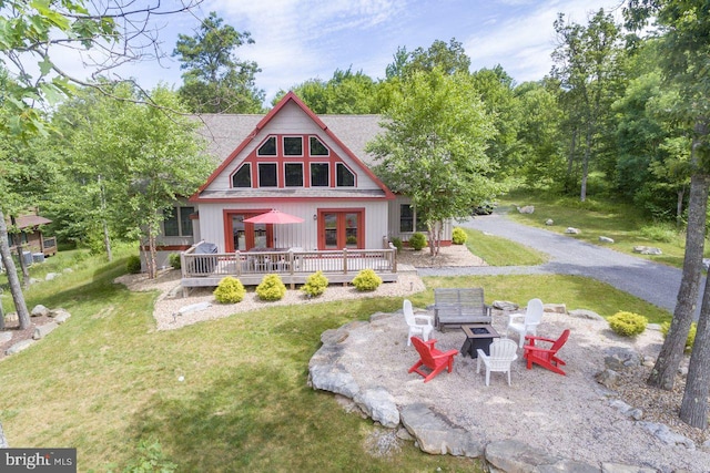193 Greenbrier Dr, Mc Henry, MD 21541 - back of property with french doors, a lawn, a fire pit, and a deck