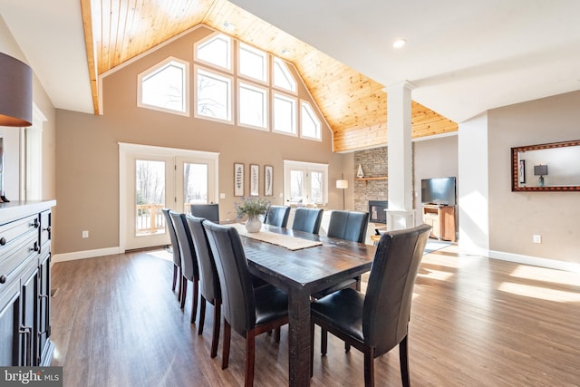 193 Greenbrier Dr, Mc Henry, MD 21541 - dining area with a stone fireplace, baseboards, wood finished floors, and high vaulted ceiling